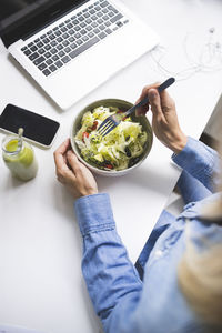 High angle view of man using laptop on table