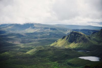 Scenic view of mountains against cloudy sky