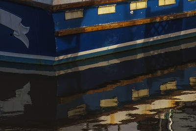 Cropped boat with reflection in water