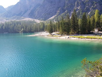 Scenic view of lake by trees against mountain