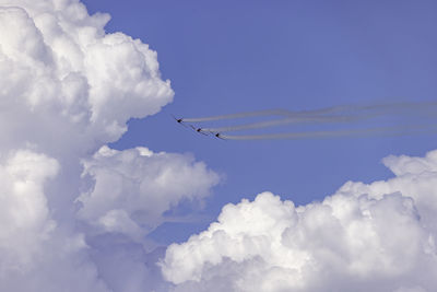 Low angle view of airplane flying against sky