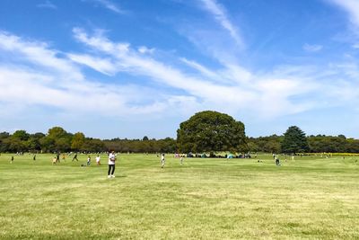 People on playing field against sky