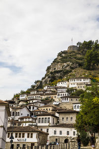 Low angle view of buildings in town against sky