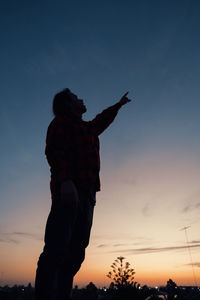 Man pointing up to the sky