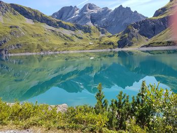 Scenic view of lake and mountains against sky