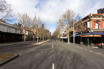 Surface level of road amidst buildings against sky