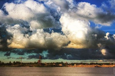 Scenic view of sea against cloudy sky