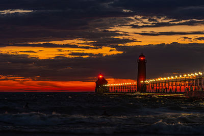 Storm clouds at sunset create colorful, dramatic lighting at the grand haven, michigan lighthouse