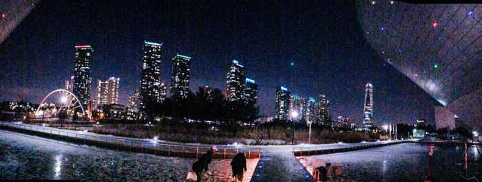 Illuminated city against sky during winter