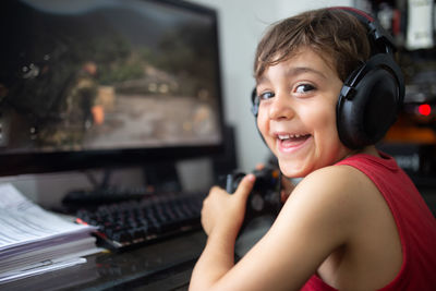 Portrait of smiling boy using mobile phone