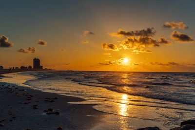 Scenic view of beach against sky during sunset