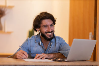 Young business man working with laptop. gray notebook for working. home office . 