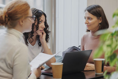 Side view of business colleagues working at office