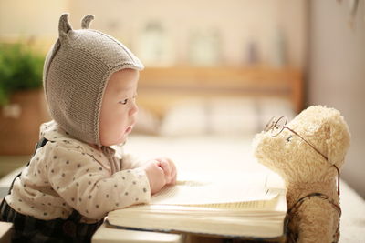 Cute boy looking at toy at home