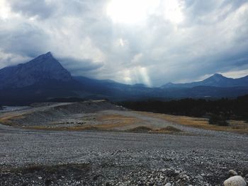 Scenic view of mountains against cloudy sky