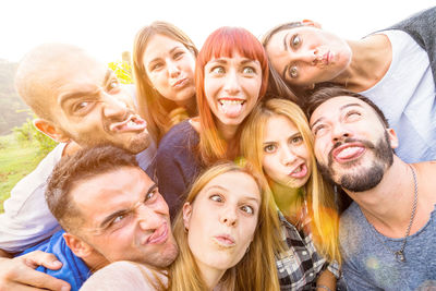 Portrait of friends making faces during party