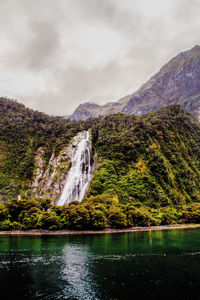 Scenic view of waterfall against sky