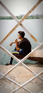 Man sitting in boat at lake