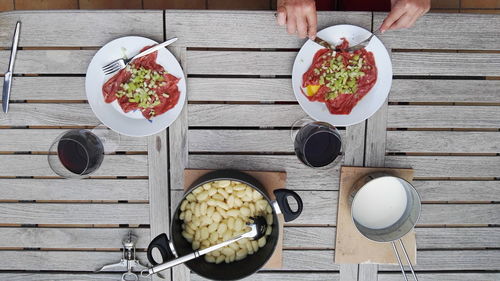 High angle view of man eating food on table