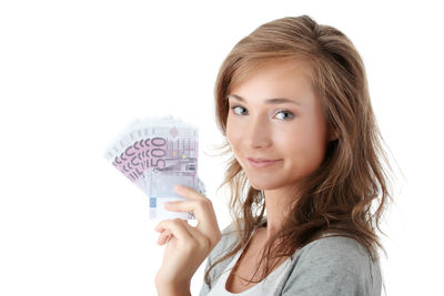 Portrait of smiling young woman against white background