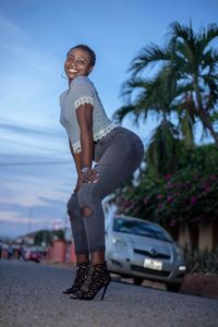 Side view of young woman standing on street