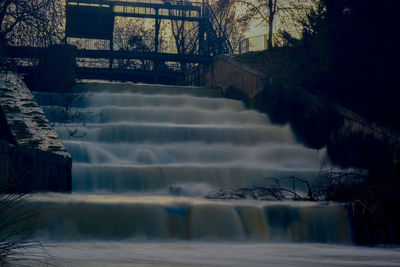 Scenic view of river against sky during winter