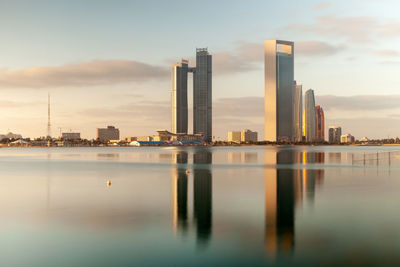 Abu dhabi skyline at sunrise. establishing shot.