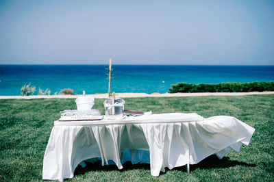 Champagne bottle in bucket on table at seaside