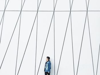 Low angle view of person photographing against sky