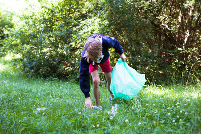 Rear view of woman standing on field