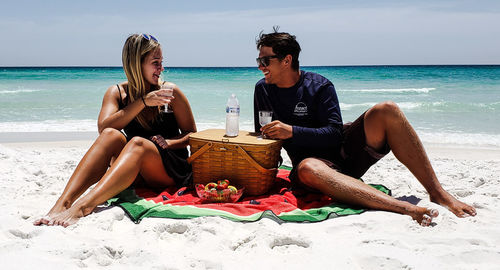 Friends drinking water from beach