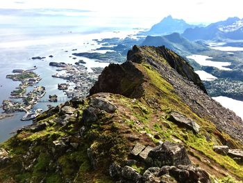 Scenic view of sea and mountains against sky