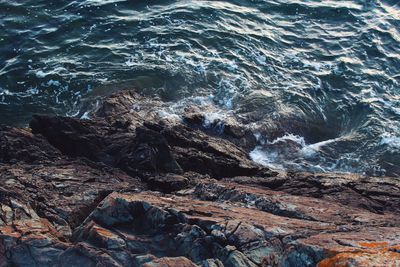 Scenic view of sea waves splashing on rock