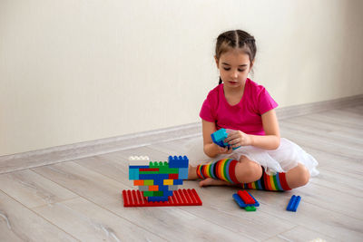 Boy playing with toy blocks at home