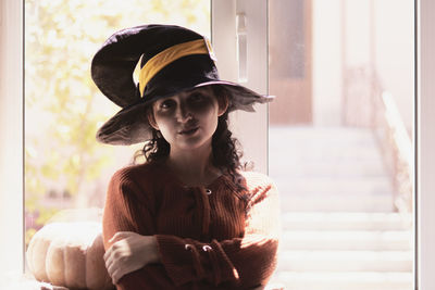 Portrait of young woman in hat