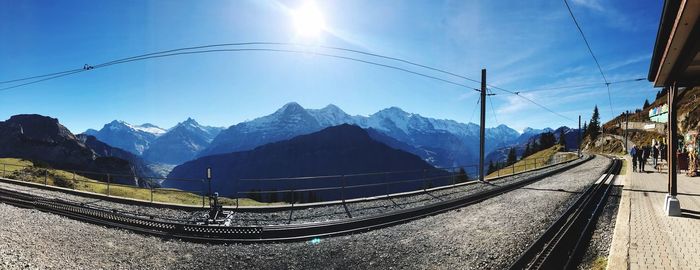 Panoramic view of railroad tracks and mountains against sky