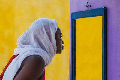 Portrait of man against yellow wall