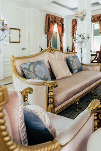 Detail image of pillows on an antique luxury sofa, living room interior design and decoration