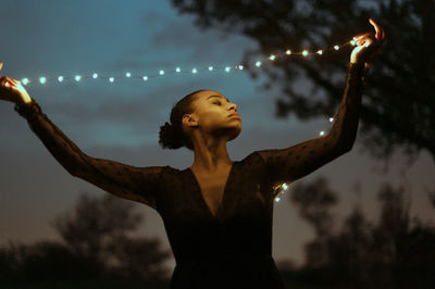 Woman looking up at night