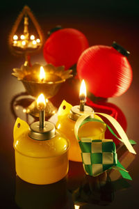 High angle view of decoration and illuminated oil lamp on table