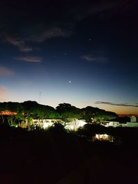 Scenic view of silhouette field against sky at night