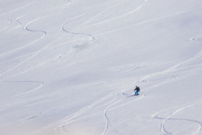 High angle view of people skiing on snowcapped mountain