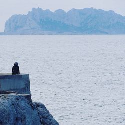 Scenic view of sea and mountains on sunny day