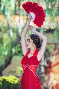 Portrait of a young woman with red flower