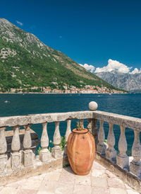 View of calm sea against mountain range