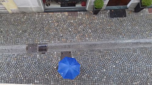 High angle view of wet umbrella on street
