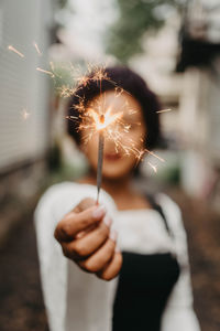 Close-up of woman holding sparkler