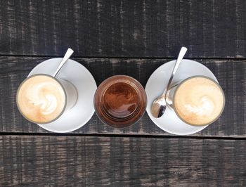 Directly above shot of coffee cup on wooden table