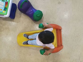 High angle view of boy playing with ball