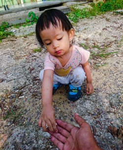 High angle view of cute girl lying on land